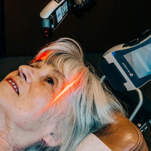 Female patient facial laser therapy