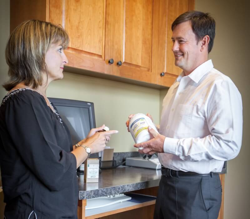 Prineville chiropractor Dr. Hanes discussing supplements with patient