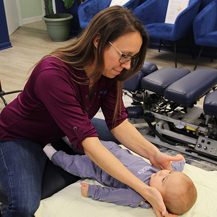 Dr Carly adjusting baby