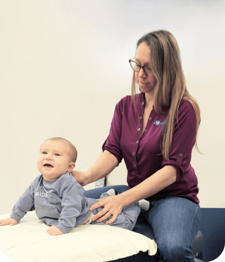 Dr Carly adjusting infant