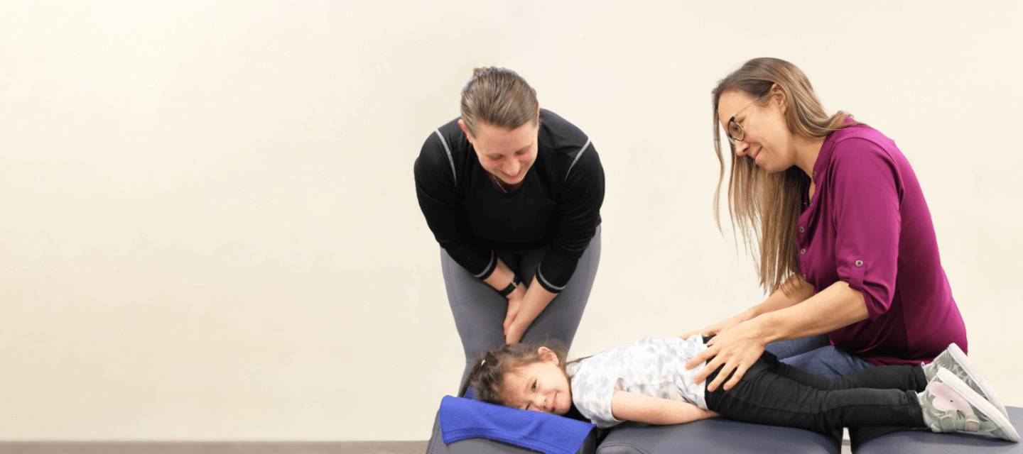 chiropractors adjusting child patient