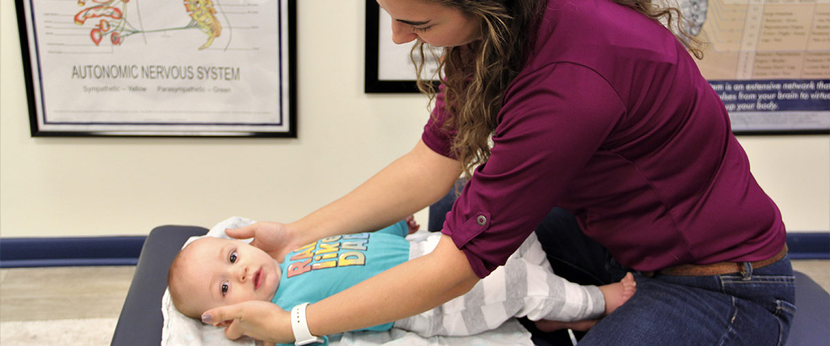 Dr Krista adjusting a baby