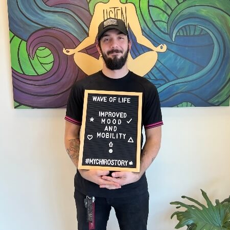 Man wearing a hat holding a sign