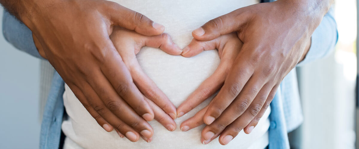 parents with hand on moms tummy