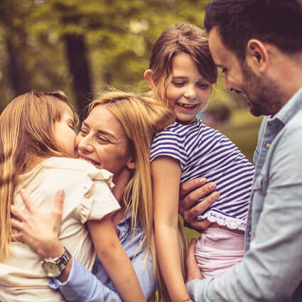 parents-holding-two-girls-sq
