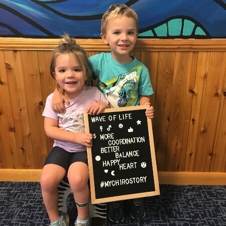 Two children holding a sign