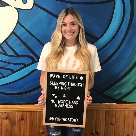 Smiling lady holding a sign