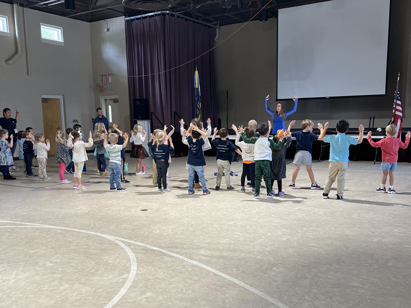 Dr. Carly & Dr. Krista teaching posture exercises to local elementary schools