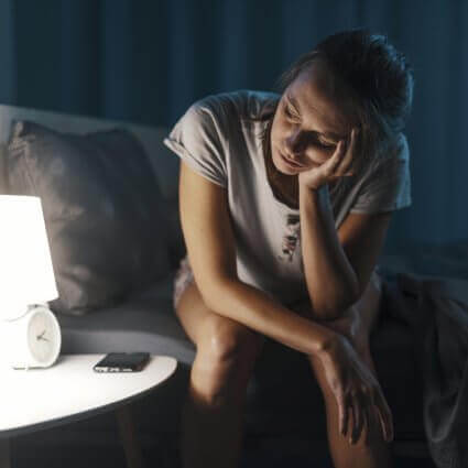 Upset woman staring at clock