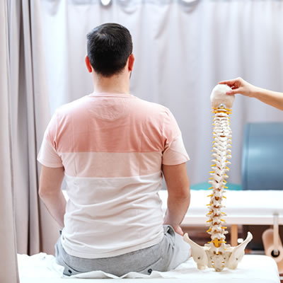 man sitting next to spine