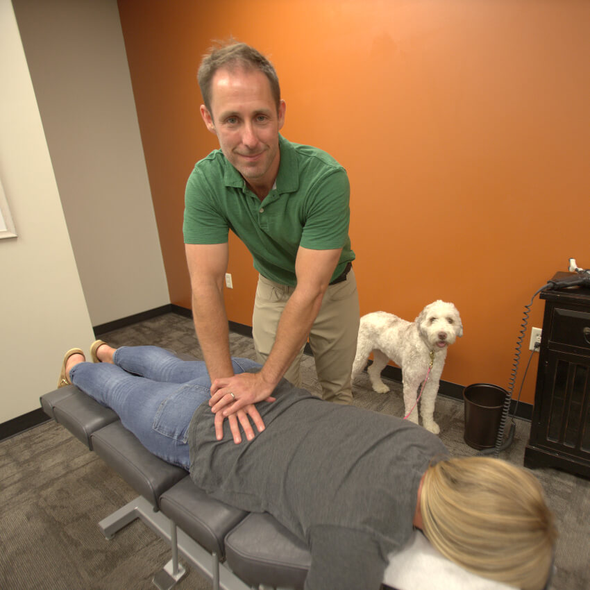Lincoln chiropractor Dr Jamey adjusting patients back