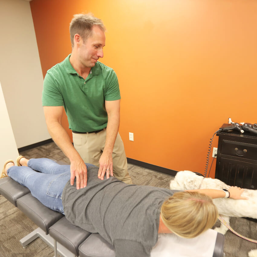Lincoln chiropractor Dr Jamey adjusting patients back