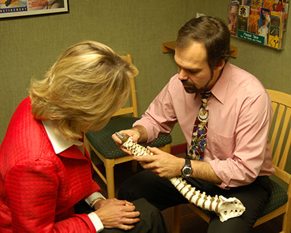 Dr. John reviewing spine with patient