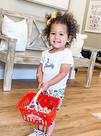 Toddler playing with a shopping basket
