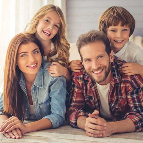 family of four smiling