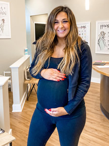 pregnant-woman-smiling-in-lobby