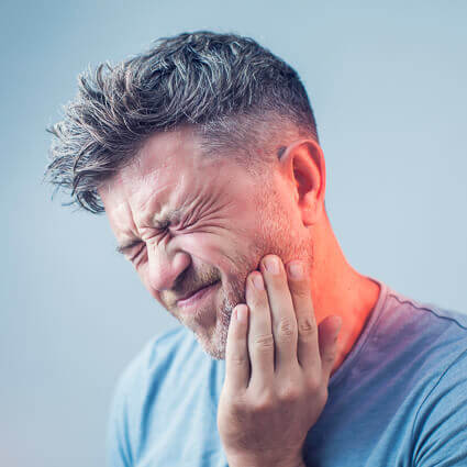 man clutching jaw with neck glowing red in pain