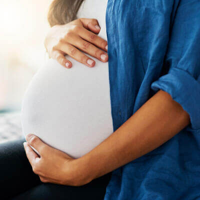 mom holding her pregnant tummy