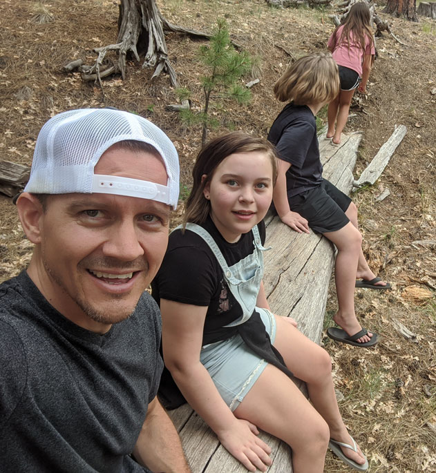 Dr. Sam Hallows with his children outdoors