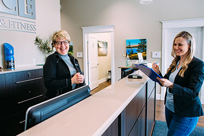 Woman filling out paperwork at reception desk