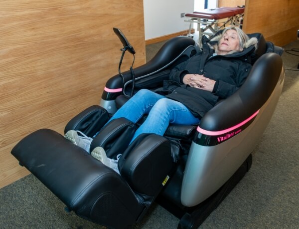 Vitality Chiropractic patient sitting in adjusting machine