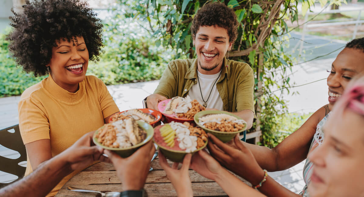 Group of young adults holding bowls of granola