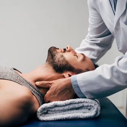 Chiropractor adjusting patient's neck