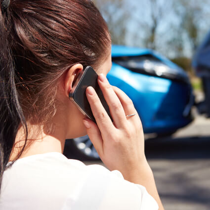 Woman on phone after car accident