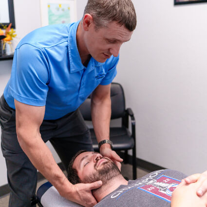 Dr. Carroll adjusting man's neck