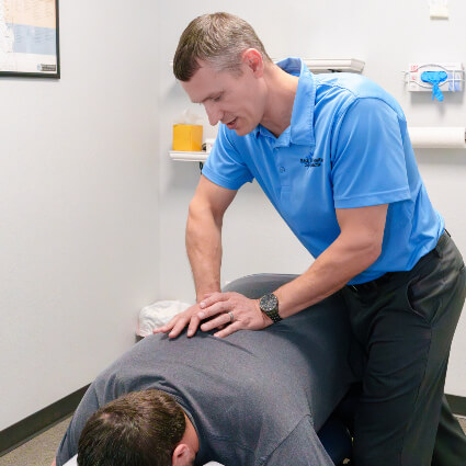 Dr. Derek adjusting man