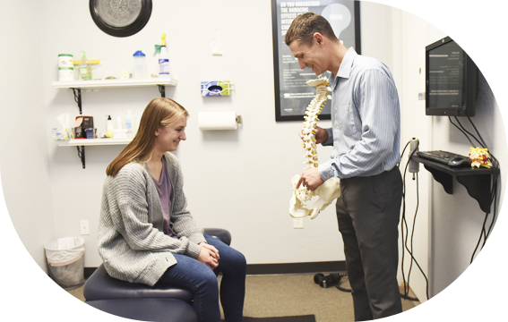 Dr. Derek showing patient a spine model