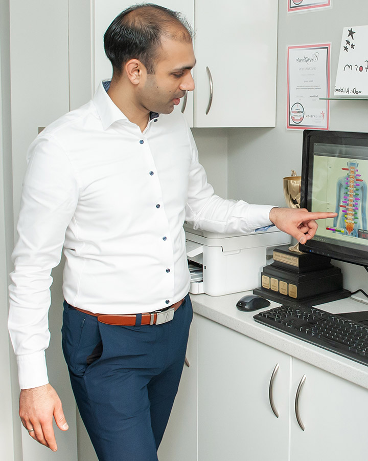 Dr. Alibhai pointing at computer
