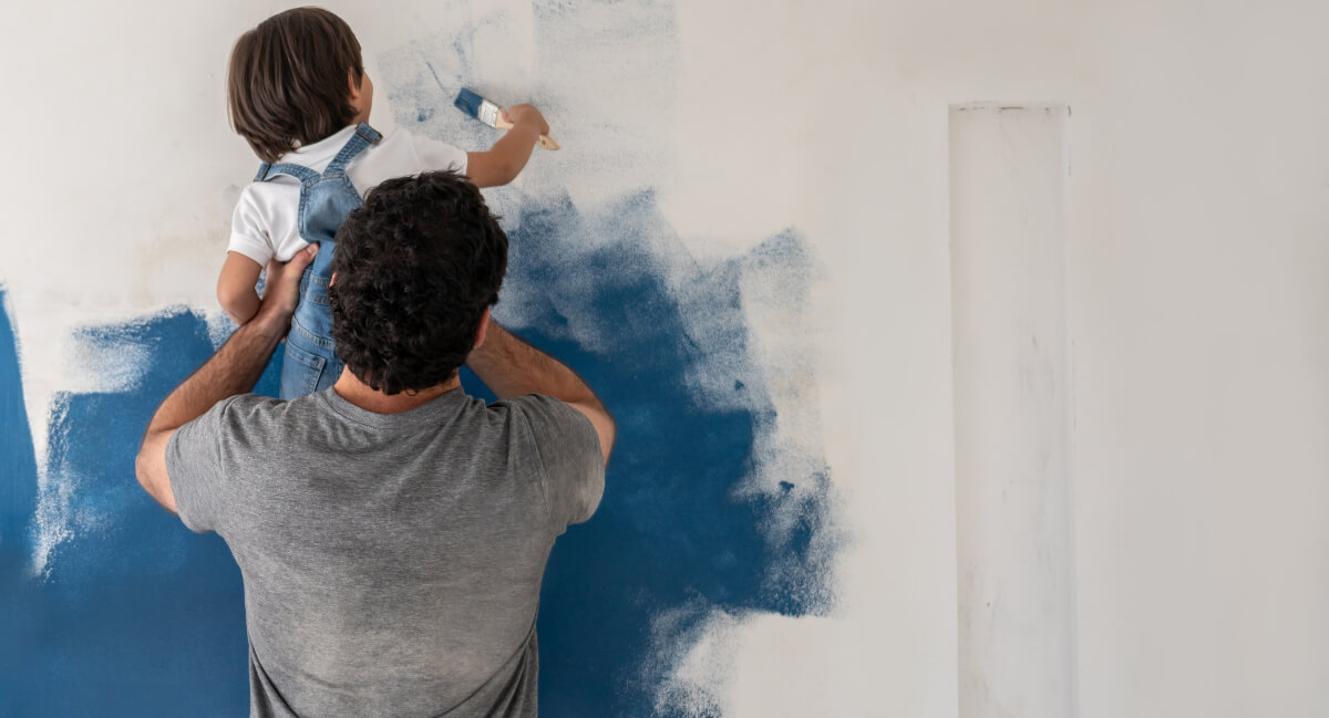 Dad and young son painting
