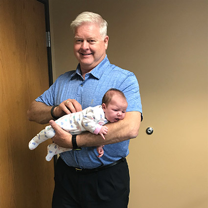 Dr. Dave holding baby
