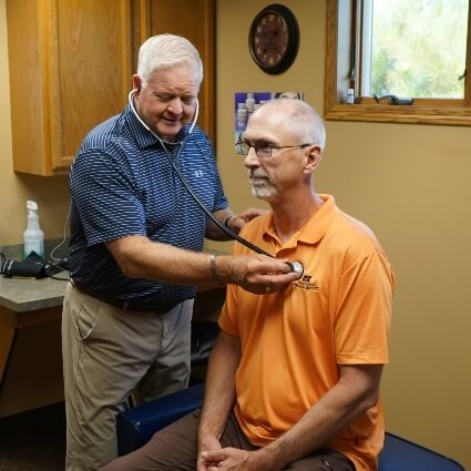 Marshall chiropractor checking patient's heartbeat