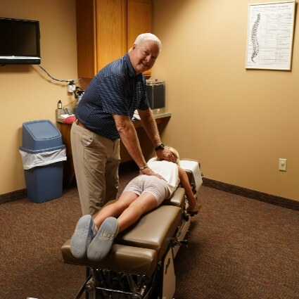 Marshall chiropractor adjusting patient's back and neck