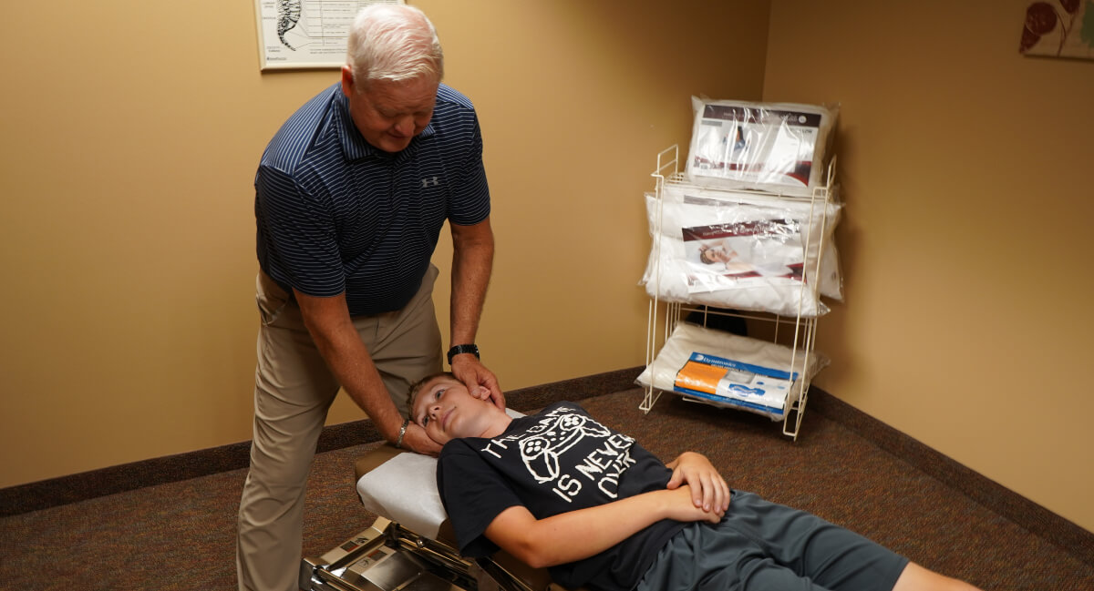 Marshall patient receiving a chiropractic neck adjustment