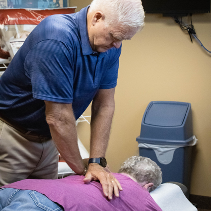 Dr. Hoganson adjusting a woman