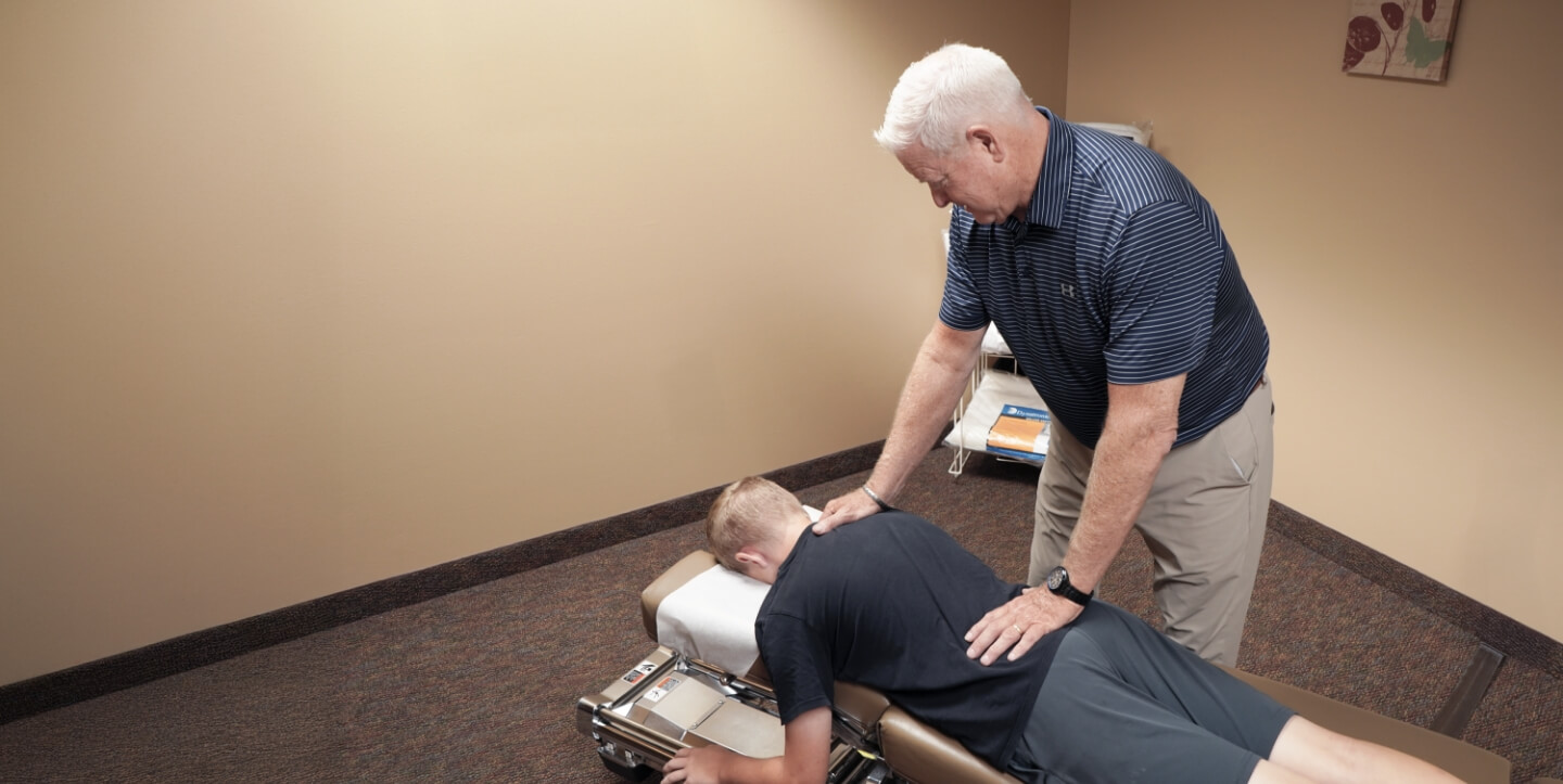 Marshall chiropractor Dr. David Hoganson adjusting patient's back