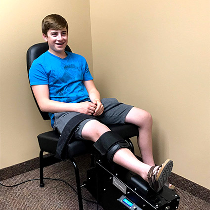 Boy knee strapped in chair