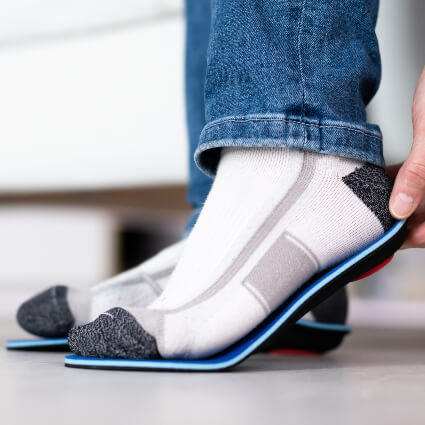 Man fitting orthotics