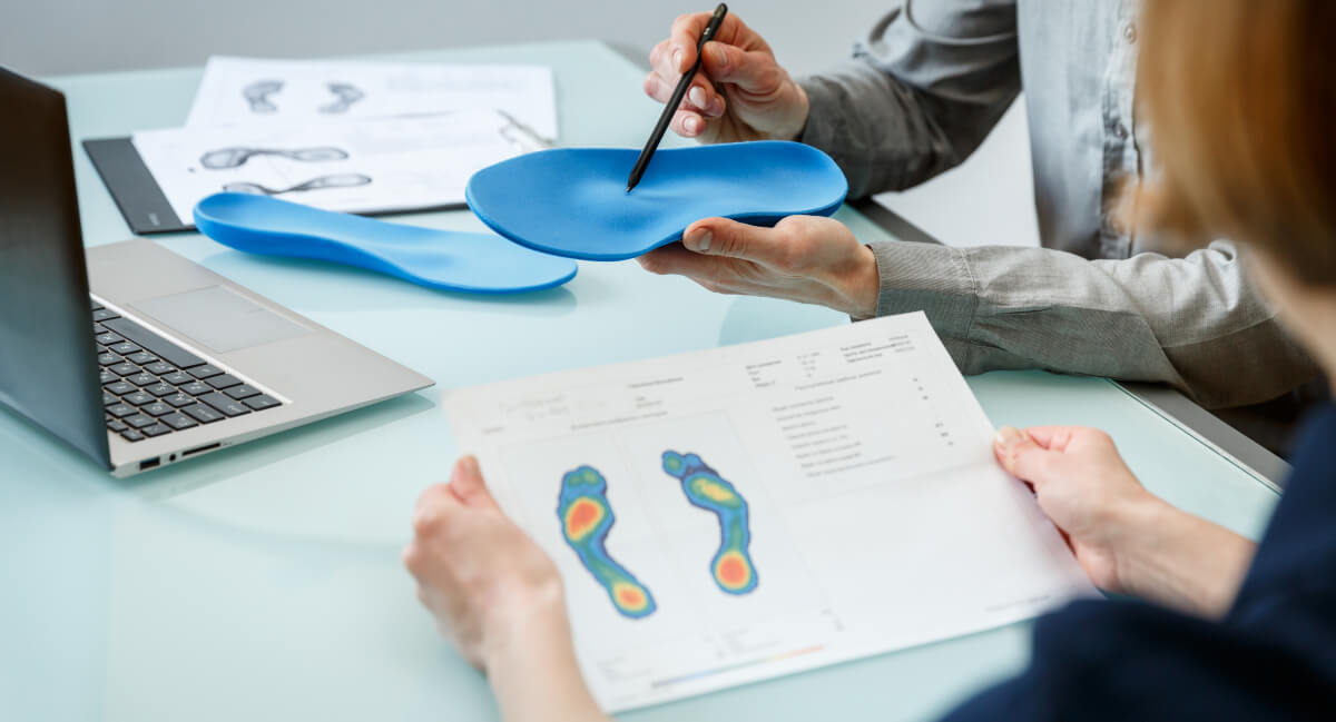 Chiropractor and patient discussing orthotics