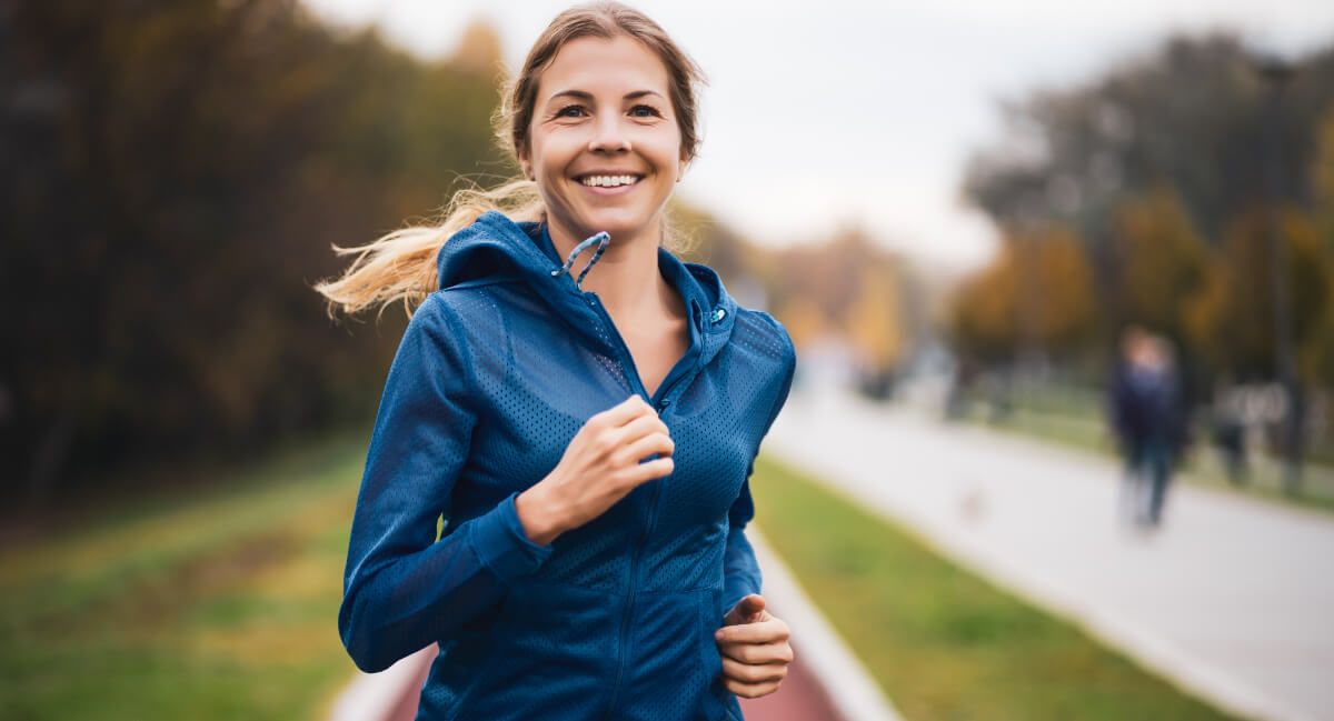 Smiling female athlete running