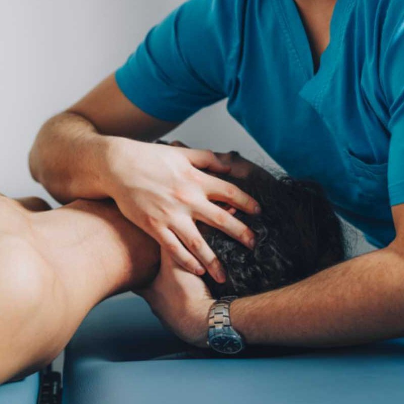 chiropractor adjusting patients neck