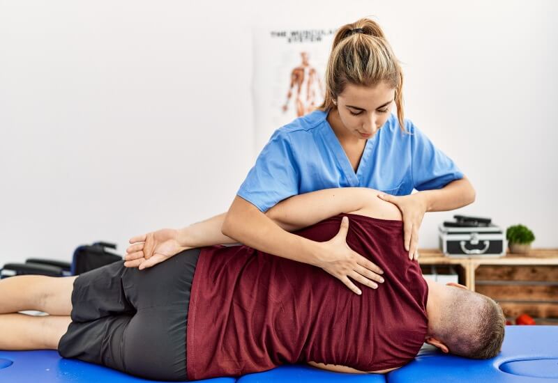 A man undergoing physical therapy at a chiropractic office in Boston, MA.