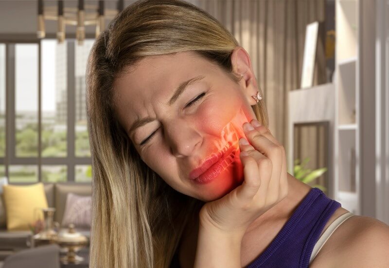 A woman suffering from jaw pain in Boston, MA