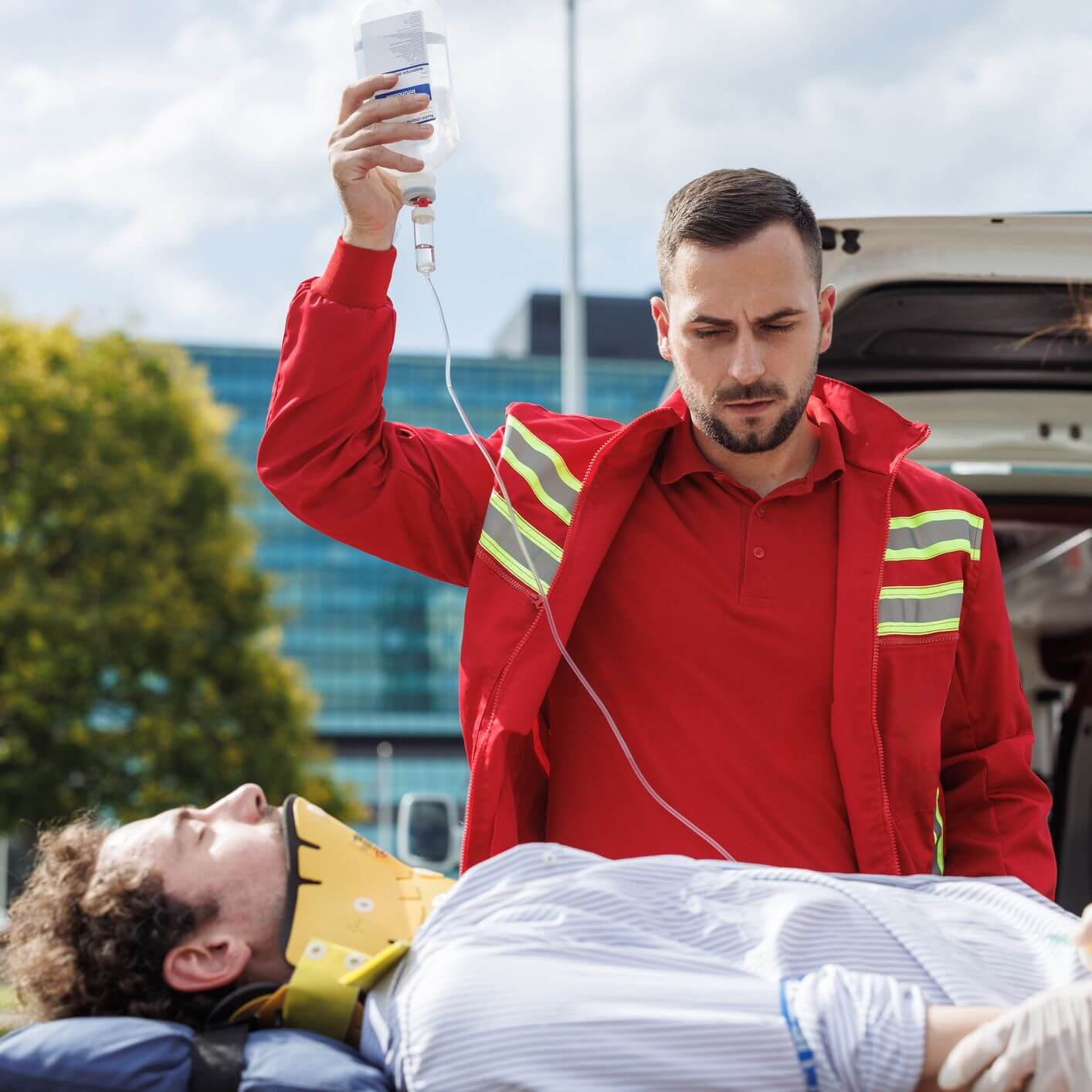 A man holding a saline line to help a patient