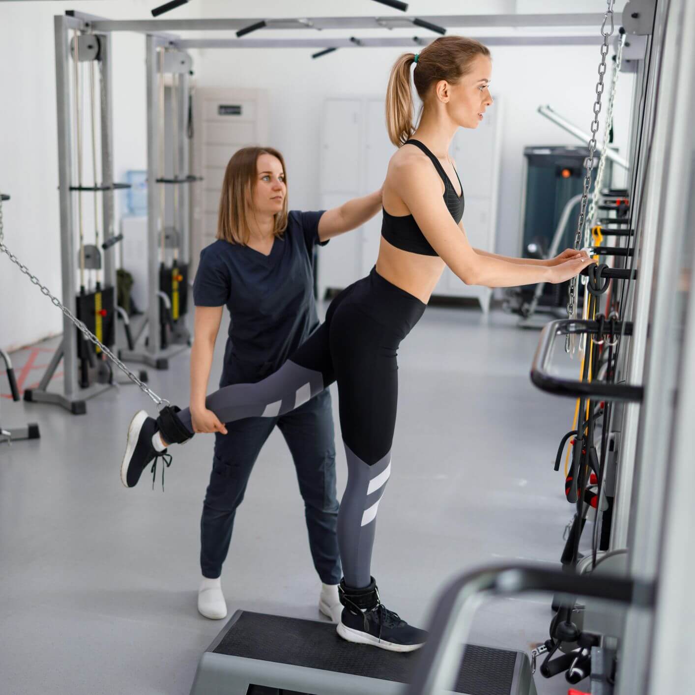 A woman exercises on a gym machine in Boston, MA, showcasing strength training in a fitness gym.