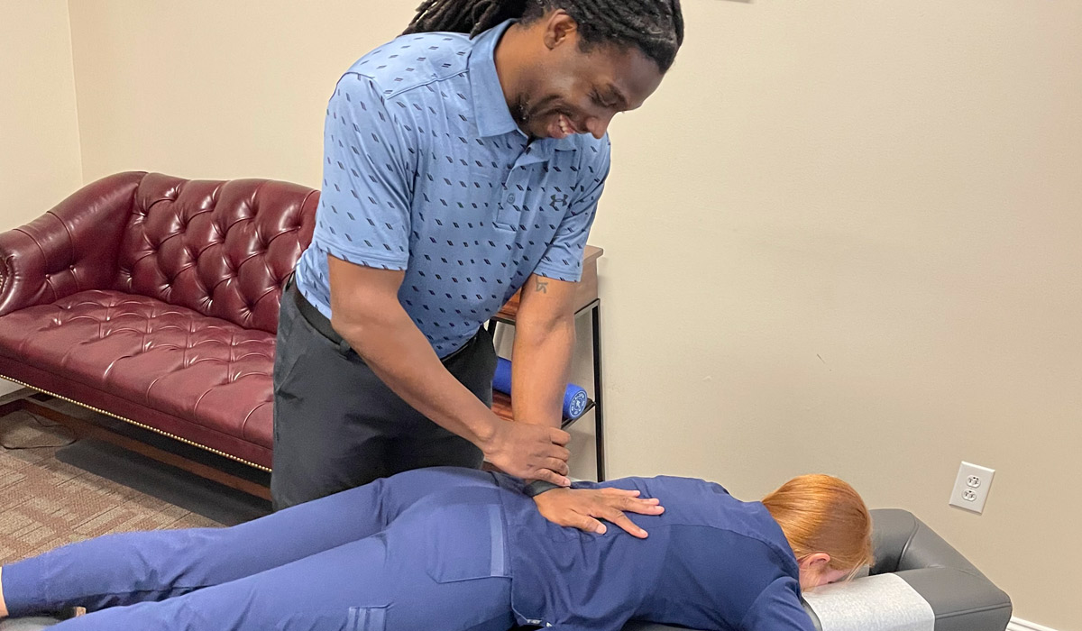 Dr. D'Juan adjusting a patient's back.