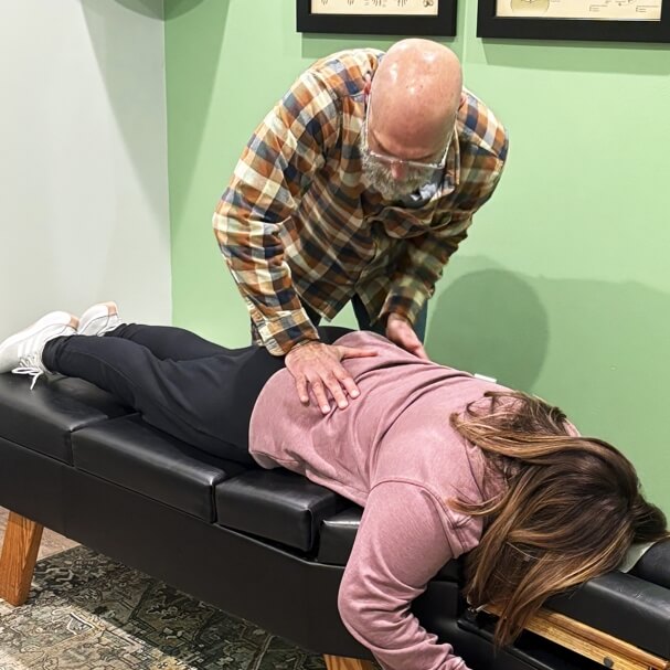 Nicholasville chiropractor Dr. Jeffries giving a lower-back adjustment to a female patient